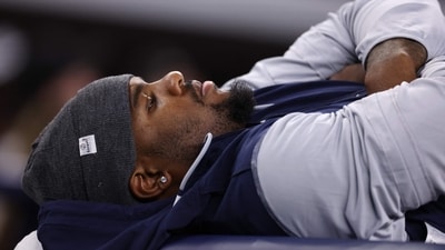 Micah Parsons #11 of the Dallas Cowboys lays on a training table during the second half vs Falcons (Getty Images via AFP) Micah Parsons #11 of the Dallas Cowboys lays on a training table during the second half vs Falcons (Getty Images via AFP)