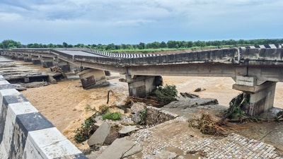 Portion of a bridge on the Jammu-Pathankot national highway was damaged due to overflowing of Sahar Khad nallah following heavy rainfall, in Kathua, on Sunday. (PTI) Portion of a bridge on the Jammu-Pathankot national highway was damaged due to overflowing of Sahar Khad nallah following heavy rainfall, in Kathua, on Sunday. (PTI)