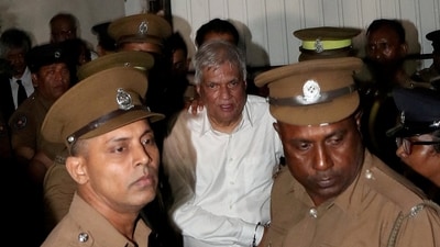 Sri Lanka's former President Ranil Wickremesinghe is escorted by prison and police officials as he leaves the Magistrate’s Court in Colombo, Sri Lanka, August 22, 2025. (REUTERS)