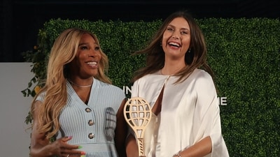 Five-time singles major champion Maria Sharapova shares a laugh with tennis great Serena Williams during her induction into the International Tennis Hall of Fame. (REUTERS)