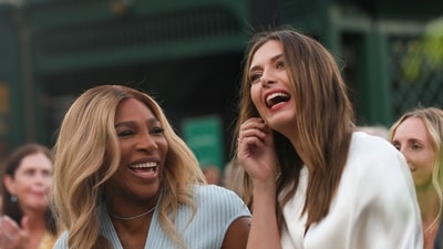 Maria Sharapova shares a laugh with tennis great Serena Williams during her induction. (REUTERS)