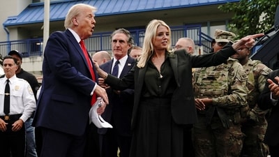 U.S. Attorney General Pam Bondi gestures whiles standing next to U.S. President Donald Trump, while he attends U.S. Park Police Anacostia Operations Facility (REUTERS)