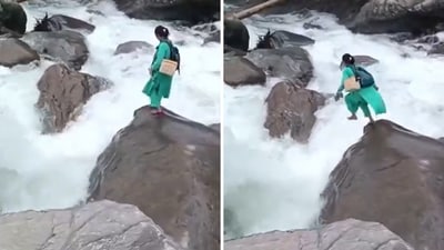 Kamla Devi, a 40-year-old health worker, was seen jumping from one boulder to another as she held her shoes in one hand. (X/@iNikhilsaini) Kamla Devi, a 40-year-old health worker, was seen jumping from one boulder to another as she held her shoes in one hand. (X/@iNikhilsaini)