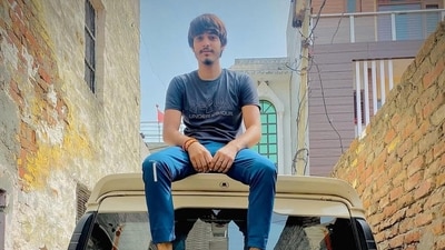 Vipin Bhati, accused of murdering his wife Nikki, in an image from his social media in which he can be seen sitting on the roof of a Mahindra Scorpio SUV. (Image: Sourced) Vipin Bhati, accused of murdering his wife Nikki, in an image from his social media in which he can be seen sitting on the roof of a Mahindra Scorpio SUV. (Image: Sourced)