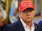 US President Donald Trump wears a 'Trump Was Right About Everything!' hat as he makes an announcement in the Oval Office at the White House in Washington, D.C.