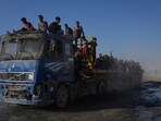 Palestinians ride on a truck used to transport humanitarian aid as it drives to Gaza City from the northern Gaza Strip, Sunday, Aug. 24, 2025. 