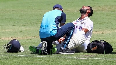 Cheteshwar Pujara reacts as he receives treatment after he is hit while batting. (AP) Cheteshwar Pujara reacts as he receives treatment after he is hit while batting. (AP)
