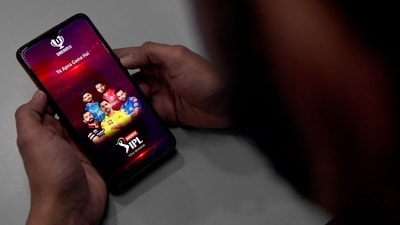 (FILES) In this photo illustration taken on October 12, 2020, a user checks the Dream11 application of the Indian Premier League (IPL) cricket tournament, on his mobile phone in New Delhi. (AFP) (FILES) In this photo illustration taken on October 12, 2020, a user checks the Dream11 application of the Indian Premier League (IPL) cricket tournament, on his mobile phone in New Delhi. (AFP)
