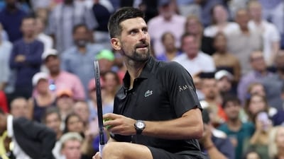 NEW YORK, NEW YORK - AUGUST 24: Novak Djokovic of Serbia hits balls into the crowd after defeating Learner Tien of the United States during their Men's Singles First Round match on Day One of the 2025 US Open at USTA Billie Jean King National Tennis Center on August 24, 2025 in the Flushing neighborhood of the Queens borough of New York City. (Getty Images via AFP) NEW YORK, NEW YORK - AUGUST 24: Novak Djokovic of Serbia hits balls into the crowd after defeating Learner Tien of the United States during their Men's Singles First Round match on Day One of the 2025 US Open at USTA Billie Jean King National Tennis Center on August 24, 2025 in the Flushing neighborhood of the Queens borough of New York City. (Getty Images via AFP)