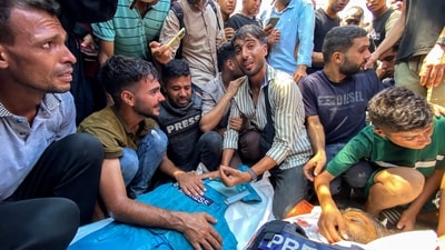People mourn over the bodies of Palestinian journalists Moaz Abu Taha (L) and Hussam al-Masri who were killed in an Israeli strike on Nasser hospital in Khan Yunis in the southern Gaza Strip. (AFP) People mourn over the bodies of Palestinian journalists Moaz Abu Taha (L) and Hussam al-Masri who were killed in an Israeli strike on Nasser hospital in Khan Yunis in the southern Gaza Strip. (AFP)