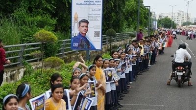 Students from Shubhanshu Shukla's alma mater, City Montessori School (CMS) stand along the road with posters waiting to greet him (Deepak Gupta/ Hindustan Times) Students from Shubhanshu Shukla's alma mater, City Montessori School (CMS) stand along the road with posters waiting to greet him (Deepak Gupta/ Hindustan Times)