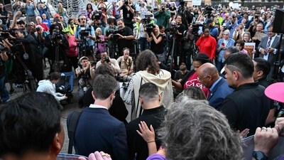 Supporters pray with Salvadoran migrant and US resident Kilmar Abrego Garcia (lower C, black shirt) as they address the media upon Abrego Garcia's arrival at a US Immigration and Customs Enforcement (ICE) field office in Baltimore, Maryland, on August 25, 2025. The US government intends to deport Garcia, a Salvadoran man at ground zero of President Donald Trump's war on illegal immigration, to Uganda next week, his lawyers said on August 23. (Photo by ROBERTO SCHMIDT / AFP) (AFP)