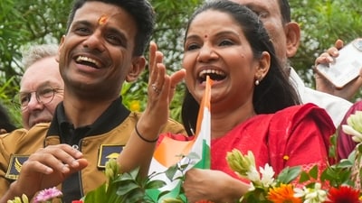 Shubhanshu Shukla, with his wife Kamna, smiles during a victory parade as he is welcomed after his historic mission to the International Space Station. (PTI) Shubhanshu Shukla, with his wife Kamna, smiles during a victory parade as he is welcomed after his historic mission to the International Space Station. (PTI)