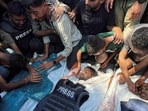 Mourners react next to the bodies of journalists Moaz Abu Taha, Hussam al-Masri, who was a contractor for Reuters, and Mohammed Salama, who Qatar-based Al Jazeera said worked for the broadcaster, after they were killed in Israeli strikes on Nasser hospital, in Khan Younis in the southern Gaza Strip.