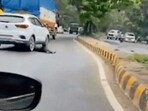 The video shows a man, aged about 40, lying on the road. A short while later he is run over by a slowly moving car, which then speeds away. He is crushed under the front and rear tyres of the car. HT couldn’t verify the authenticity of the video. (Video Grab/HT Photos) The video shows a man, aged about 40, lying on the road. A short while later he is run over by a slowly moving car, which then speeds away. He is crushed under the front and rear tyres of the car. HT couldn’t verify the authenticity of the video. (Video Grab/HT Photos)