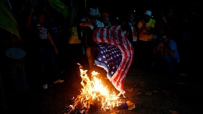 Demonstrators burn a US flag during a protest in defense of national sovereignty after trade tariffs and sanctions were imposed by the US government on Brazil (AFP) Demonstrators burn a US flag during a protest in defense of national sovereignty after trade tariffs and sanctions were imposed by the US government on Brazil (AFP)