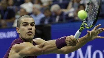 Carlos Alcaraz returns a shot to Reilly Opelka during the first round of the US Open. (AP)
