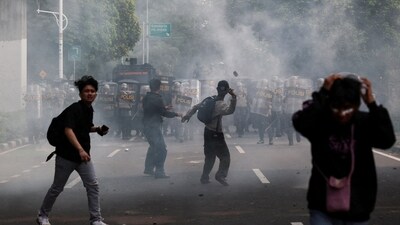 Protesters react as they clash with riot police during a protest against, what the demonstrators say, are exorbitant allowances for Indonesian parliament members (REUTERS)