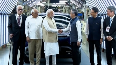Prime Minister Narendra Modi with Gujarat Chief Minister Bhupendra Patel and others during a flagging off ceremony of Maruti Suzuki's first electric vehicle e-Vitara. (@Narendra Modi )