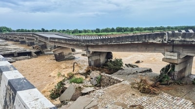 Portion of a bridge on the Jammu-Pathankot national highway was damaged due to overflowing of Sahar Khad nallah following heavy rainfall, in Kathua, on Sunday. (PTI) Portion of a bridge on the Jammu-Pathankot national highway was damaged due to overflowing of Sahar Khad nallah following heavy rainfall, in Kathua, on Sunday. (PTI)