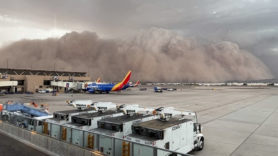 A large cloud of dust at the Phoenix Sky Harbor International Airport on August 25, 2025 in Phoenix, Arizona. A dust storm swept across the US city of Phoenix on August 25, disrupting flights with dark clouds billowing across the airport.(AFP)