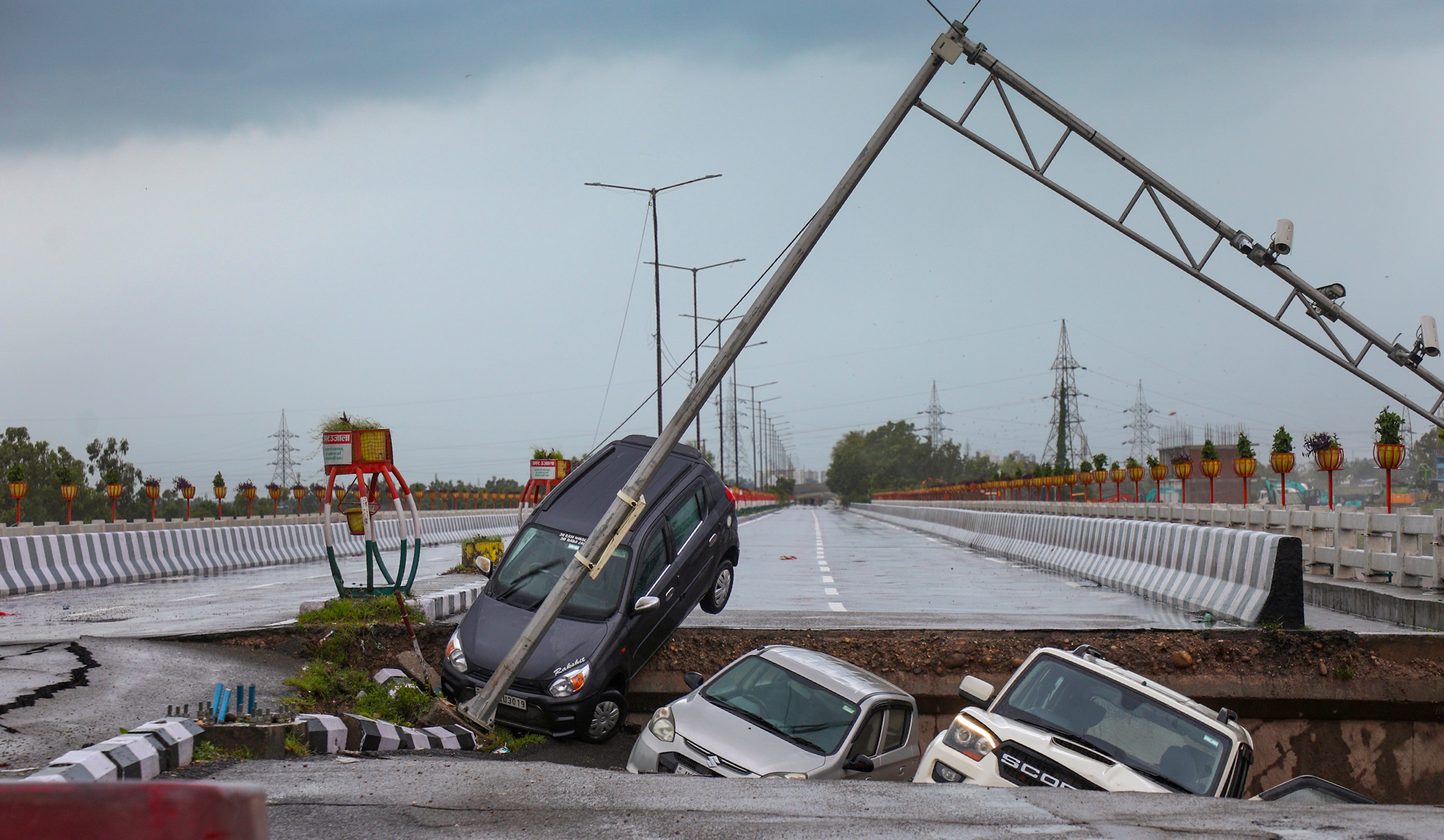 Vehicles stuck as a portion of the Fourth Tawi Bridge damaged after relentless rainfall, at Bhagwati Nagar, in Jammu, (PTI) Vehicles stuck as a portion of the Fourth Tawi Bridge damaged after relentless rainfall, at Bhagwati Nagar, in Jammu, (PTI)
