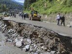 People walking over a portion of a road that was washed away by the Beas river following heavy rainfall in Kullu district of Himachal Pradesh on Wednesday. (PTI Photo) People walking over a portion of a road that was washed away by the Beas river following heavy rainfall in Kullu district of Himachal Pradesh on Wednesday. (PTI Photo)