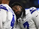 Dallas Cowboys cornerback Trevon Diggs, right, leans on quarterback Dak Prescott (4) 