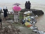 Work under way to strengthen embankment in Dhulewal village in Ludhiana district. (HT photo)