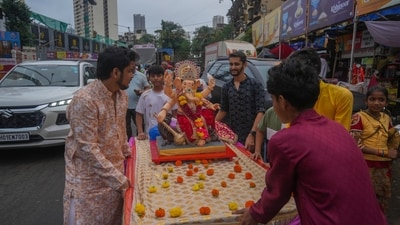 Devotees take home an idol of Hindu god Ganesha for worship during Ganesh Chaturthi festival celebrations in Mumbai (AP) Devotees take home an idol of Hindu god Ganesha for worship during Ganesh Chaturthi festival celebrations in Mumbai (AP)