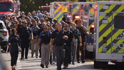 Law enforcement officers gather outside the Annunciation Church’s school (AP/File) Law enforcement officers gather outside the Annunciation Church’s school (AP/File)