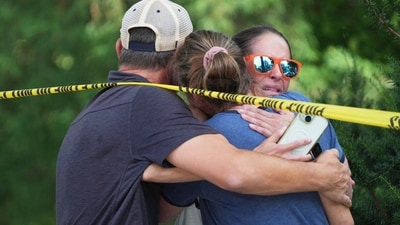 Community members embrace after a shooting at the Annunciation Catholic School on Wednesday, Aug. 27, 2025, in Minneapolis. (Alex Kormann/Star Tribune via AP) (AP) Community members embrace after a shooting at the Annunciation Catholic School on Wednesday, Aug. 27, 2025, in Minneapolis. (Alex Kormann/Star Tribune via AP) (AP)