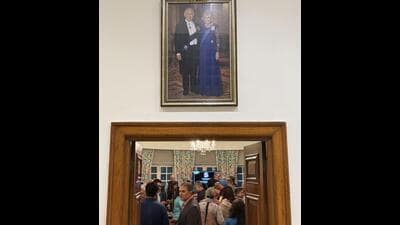 These guests sauntered into the living room, walking right under the portrait of their British hostess’s king and queen. (HT) These guests sauntered into the living room, walking right under the portrait of their British hostess’s king and queen. (HT)