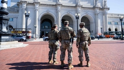 Armed members of the National Guard patrol outside of Union Station in Washington DC. (AFP) Armed members of the National Guard patrol outside of Union Station in Washington DC. (AFP)