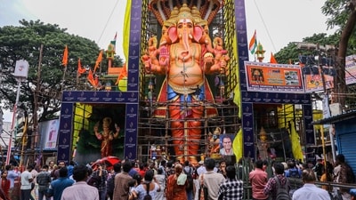 People visit a 69-ft tall idol of Lord Ganesha, made using eco-friendly clay and natural colours in Hyderabad. (PTI) People visit a 69-ft tall idol of Lord Ganesha, made using eco-friendly clay and natural colours in Hyderabad. (PTI)