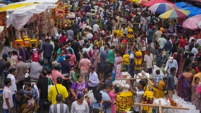 People crowd a market to buy decorative flowers and other material during Ganesh Chaturthi festival celebrations in Mumbai, (AP) People crowd a market to buy decorative flowers and other material during Ganesh Chaturthi festival celebrations in Mumbai, (AP)