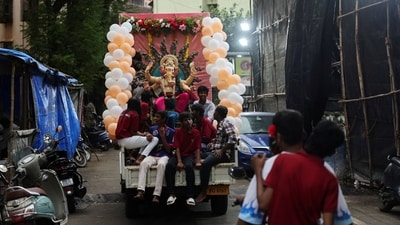 People transport an idol of the Hindu god Ganesh at the back of a vehicle for the ten-day-long Ganesh Chaturthi festival, in Mumbai. (Reuters)