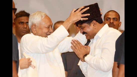 Bihar chief minister Nitish Kumar honouring Bihar minister Jama Khan during centenary celebration function of the Bihar State Madarsa Education Board at Bapu Sabhagar in Patna on August 21. (Santosh Kumar/HT)