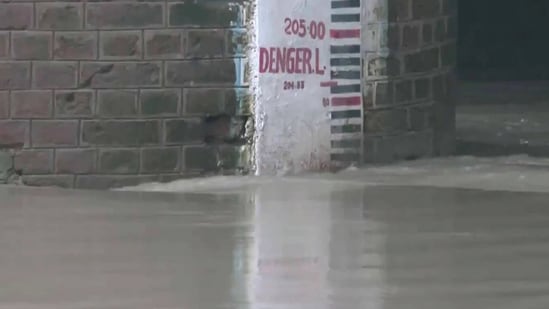 Visuals from the Old Yamuna Bridge shows the Yamuna River continues to flow near the danger mark in Delhi. (ANI)