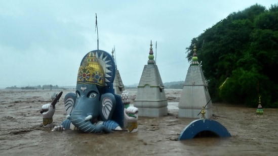 A temple lies partially submerged in floodwaters after heavy rain induced a rise in the water level of river Tawi in Jammu on August 26, 2025. (AFP)