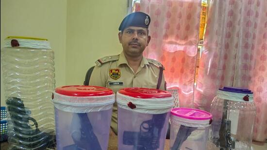 The police recovered pistols, country-made pistol, live cartridges, Innova car and 18 empty shell cartridges from the spot, in Gurugram on Wednesday. (HT PHOTO)