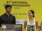 Delhi's Anahat Singh and Tamil Nadu's Velavan Senthilkumar with their trophies at the 81st National Squash Championship in New Delhi. (PTI)