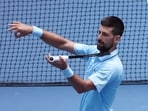 Novak Djokovic celebrates his win over Zachary Svajda with a violin celebration dedicated to his daughter.