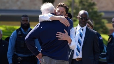 Minnesota Gov. Tim Walz hugs Minneapolis Mayor Jacob Frey outside Annunciation Catholic School in the aftermath of Wednesday’s shooting. AP/PTI(AP08_28_2025_000032A) (AP) Minnesota Gov. Tim Walz hugs Minneapolis Mayor Jacob Frey outside Annunciation Catholic School in the aftermath of Wednesday’s shooting. AP/PTI(AP08_28_2025_000032A) (AP)