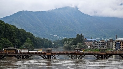In Srinagar, the Jhelum is seen to flow dangerously close to the bridge constructed over it, after the state was battered by heavy rains since Tuesday. (Tauseef Mustafa/AFP) In Srinagar, the Jhelum is seen to flow dangerously close to the bridge constructed over it, after the state was battered by heavy rains since Tuesday. (Tauseef Mustafa/AFP)
