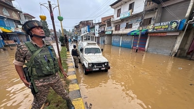 An army personnel is seen standing amid a waterlogged street in Kashmir's Anantnag after the state saw incessant rains since Tuesday. (PTI) An army personnel is seen standing amid a waterlogged street in Kashmir's Anantnag after the state saw incessant rains since Tuesday. (PTI)