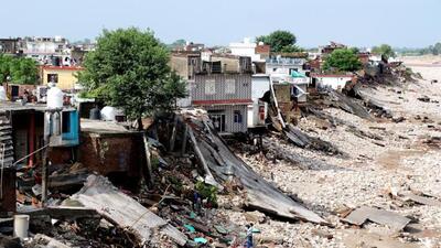 Damaged houses along the banks of the Tawi river a day after it was flowing in spate due to heavy rainfall in Jammu on Thursday. (PTI Photo)