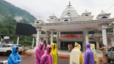 Devotees wait at the entrance of the Vaishno Devi temple premises after the pilgrimage was temporarily suspended after Jammu was pumelled by heavy rains since Tuesday. (PTI) Devotees wait at the entrance of the Vaishno Devi temple premises after the pilgrimage was temporarily suspended after Jammu was pumelled by heavy rains since Tuesday. (PTI)