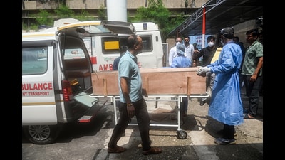 Health workers carry the body of a pilgrim who died in a landslide on the route to the Shri Mata Vaishno Devi Temple, being shifted to the Government Medical Hospital, in Jammu on Thursday. (ANI) Health workers carry the body of a pilgrim who died in a landslide on the route to the Shri Mata Vaishno Devi Temple, being shifted to the Government Medical Hospital, in Jammu on Thursday. (ANI)
