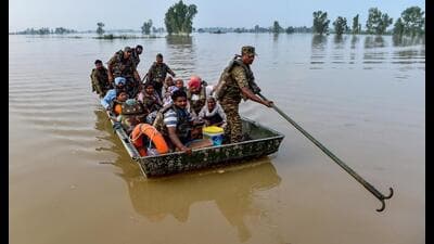 Indian Army personnel rescue local residents using a boat to evacuate through the flooded waters of the Beas river at Baoopur village in the Kapurthala district. (AFP) Indian Army personnel rescue local residents using a boat to evacuate through the flooded waters of the Beas river at Baoopur village in the Kapurthala district. (AFP)